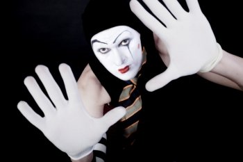 portrait of mime in white gloves on black