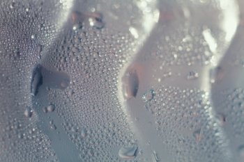 Texture of a glass bottle with water droplets