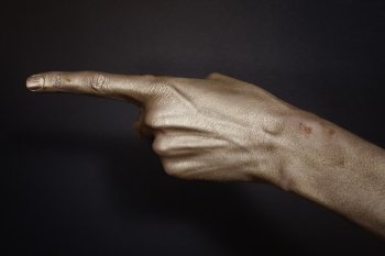 men’s hands indicate in the gold make-up