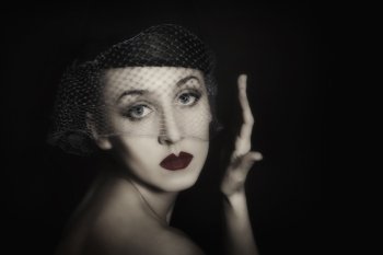 Retro portrait of beautiful young woman in veil