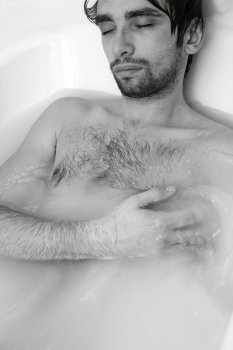 monochrome portrait of  young sexual guy in the bath