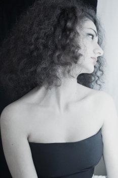 Portrait of young  girl with curly hair closeup