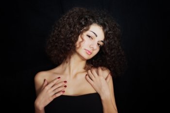 Portrait of  curly girl with red manicure closeup