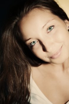 Portrait of a beautiful young brunette woman with green eyes
