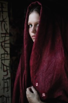 Portrait of a beautiful young caucasian girl in a cape