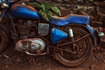 One Old dirty blue motorcycle outdoors