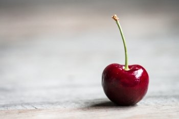 Closeup of a cherry on wooden background