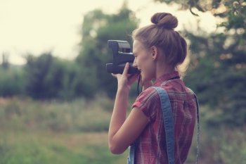 Girl photographer shooting outdoors