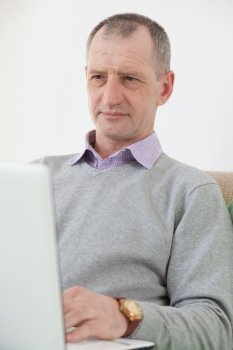Adult man using a laptop at home