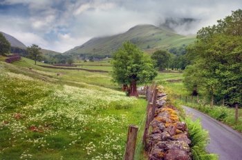 Summer time in the Lake District. Low Mill Bridge near Grasmere looking towards Great Tongue, Cumbria, England.