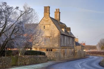 Pretty Cotswold farmhouse in wintertime, Gloucestershire, England.