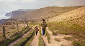 Mother and son on a coastal walk near West Lulworth, Dorset, England.