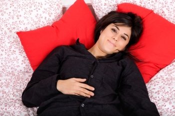 young beautiful sensual woman in bed, studio picture