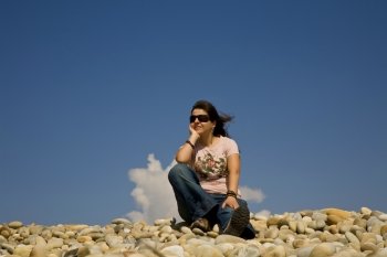 young woman at the beach with the sky as background