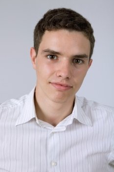 young casual man against a grey background