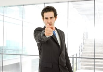 young business man in a suit pointing with his finger at the office