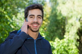 happy young casual man on the phone outdoor