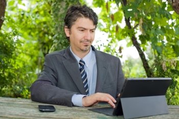 happy businessman with digital tablet, outdoors