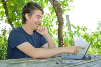 young happy man with a tablet pc, outdoor