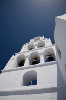 white bell tower in the greek island of santorini