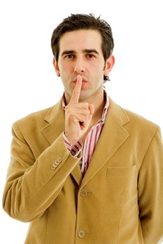 young man showing silence gesture with his finger in the mouth 