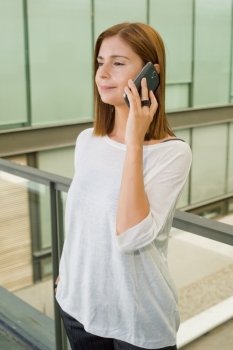 businesswoman talking on mobile phone in office building