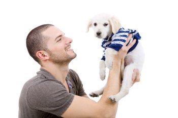 young man holding a cute small dog isolated on white