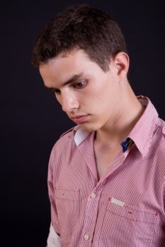 young casual man against a black background