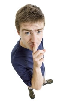 young casual man full body with his finger on lips