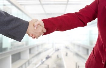 business couple shaking hands at the office