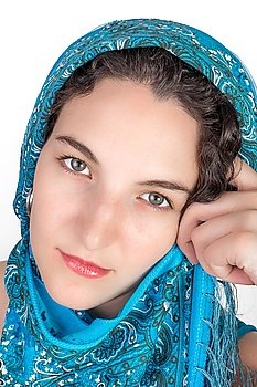 Young female model with black hair and a blue open shoulder summer dress, wearing a blue shawl over her hair.