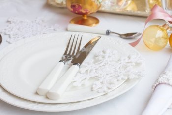 Tableware set. Tableware for christmas - set of plates  and utencils on white tablecloth 