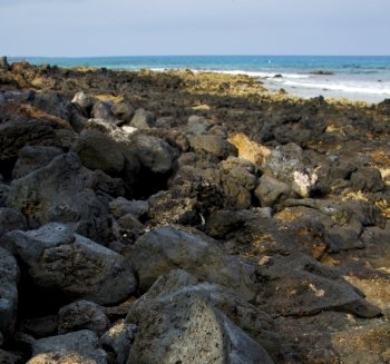 in lanzarote  isle foam rock spain landscape  stone sky cloud beach   water 
