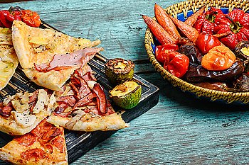 La carte pizza on cutting board. Pizza stuffed with meat and baked vegetables in rustic style