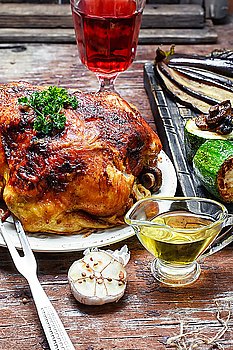 grilled chicken and red wine. Meat dish of baked chicken and glass of red wine