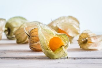 Gooseberries in bright light on a wooden table