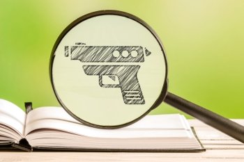 Weapon information with a pencil drawing of a gun in a magnifying glass