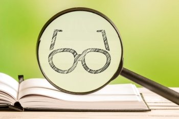 Reading information with a pencil drawing of a pair of glasses in a magnifying glass