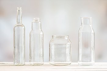 Glass bottles on a row on a wooden table
