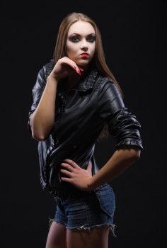 Fashion portrait of young girl on black