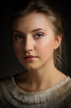 Beauty portrait of young girl on grey
