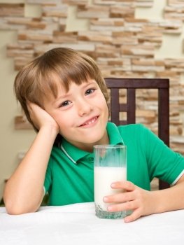 Little boy with milk at the table