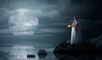 Young elven girl with lantern on night sea coast