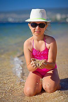 Little girl on sea coast