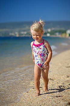 Little girl on sea coast