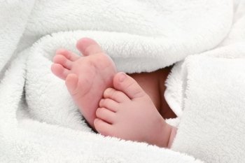 baby feet in white bath towel