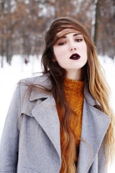 Close up fashion portrait of alluring woman model with luxury fashion make-up, dark black lips makeup, perfect skin and long ombre hair. Trends colors, marsala wine color lipstick, eyebrows, sexy hair