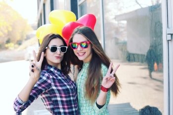 Two young girls showing peace sign