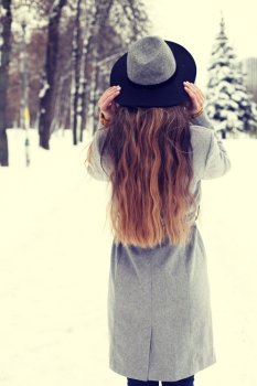 beautiful hipster girl in winter hat. photo toned style instagram flters