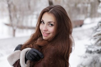 Portrait of a beautiful young woman in the winter.